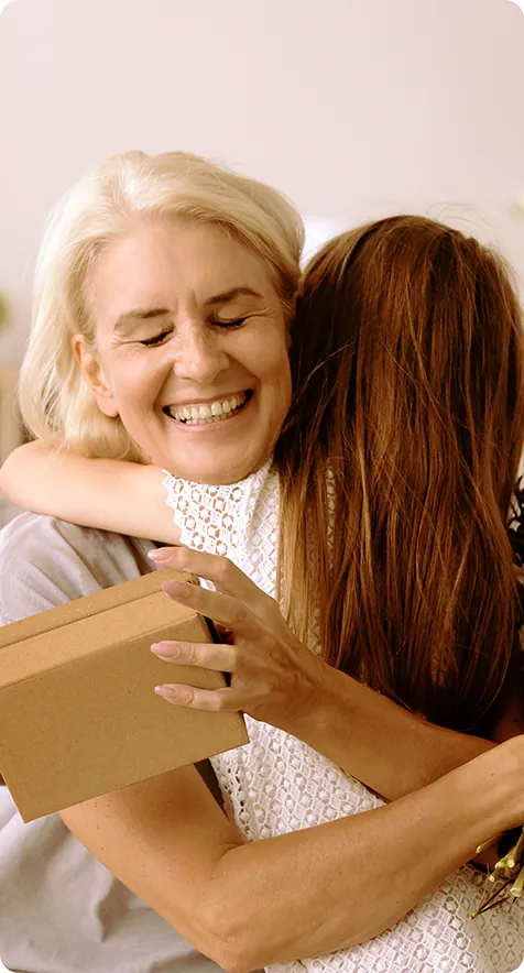 Una mujer dando un largo abrazo a su madre