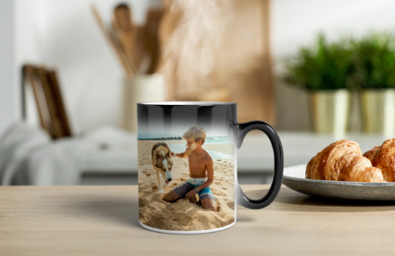 Taza mágica personalizada de Printerpix que cambia con el calor con foto personalizada de un bebé revelada|Taza mágica personalizada de Printerpix que cambia con el calor con foto personalizada de un bebé revelada|Niño sosteniendo una taza mágica personalizada con su foto|Taza mágica con foto de gato mientras se vierte té en ella sobre el escritorio|Pareja sosteniendo dos tazas mágicas que cambian con el calor con texto personalizado de Printerpix|Taza mágica personalizada con foto revelada de una joven|||||