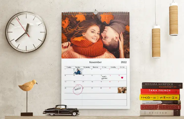 Pareja romántica en la sala de estar con calendario de pared personalizado 2020 con foto de propuesta